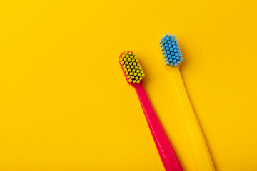 Oral care. Bright toothbrushes on yellow paper. Dentist concept. Flat lay. copy space.Place for text