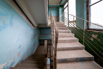 Concrete stairs with handrails in a building in need of repair