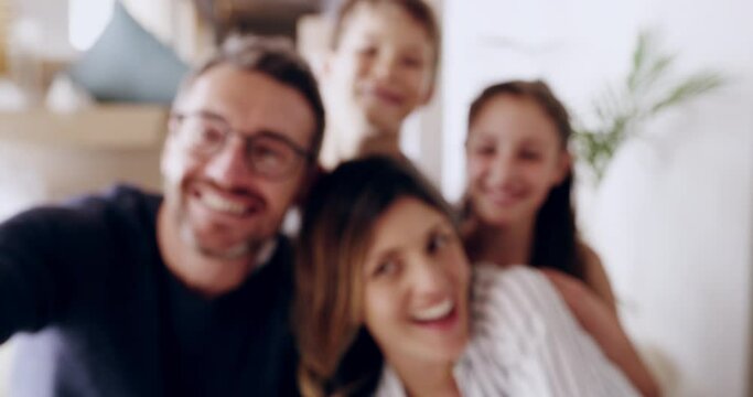 Phone, smile and love with a family taking a selfie together with a mother, father and children giving a smile. Man, woman and kids in their home together with a smartphone to take a photograph
