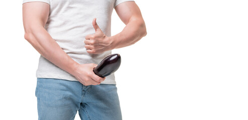 Guy crop view giving thumb holding eggplant at crotch level imitating erect penis, copy space