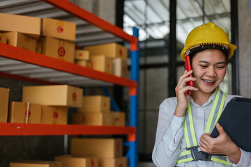 Logistic workers are checking and preparing the product parcel cardboard box in warehouse.