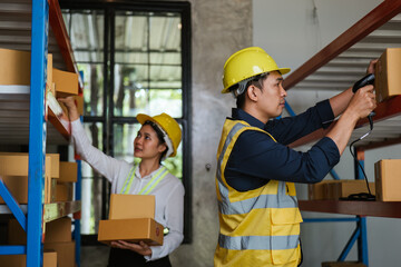 Logistic workers are checking and preparing the product parcel cardboard box in warehouse.