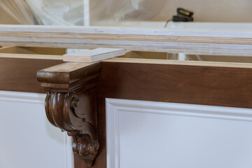 Installation of corbels on the island in new kitchen for granite countertops. © ungvar
