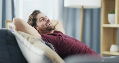 Relax, sofa and man stretching in living room for comfort, lounge and lifestyle at home. Happy, content and enjoying calm weekend satisfaction or day off alone on couch in apartment - Powered by Adobe