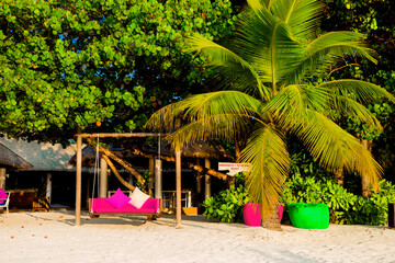 Landscape on Maldives island, luxury water villas resort and wooden pier. Beautiful sky and ocean and beach with palms background for summer vacation holiday and travel concept. Luxury travel.