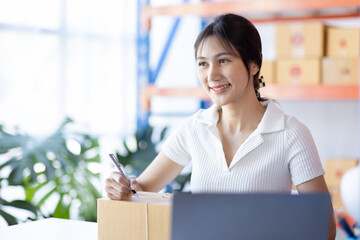 Young Asian woman entrepreneur SME Startup small Business owner working at home for online shopping and preparing package product deliver to customers, Asian Online SME business entrepreneurs ideas,