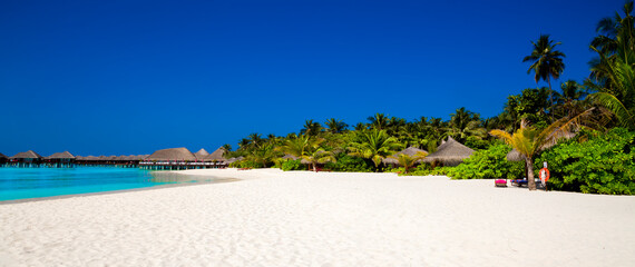 Landscape on Maldives island, luxury water villas resort and wooden pier. Beautiful sky and ocean...