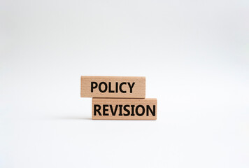 Policy revision symbol. Concept word Policy revision on wooden blocks. Beautiful white background. Business and Policy revision concept. Copy space