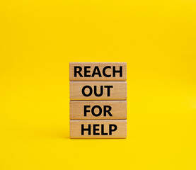 Reach out for help symbol. Wooden blocks with words Reach out for help. Beautiful yellow background. Business and Reach out for help concept. Copy space.