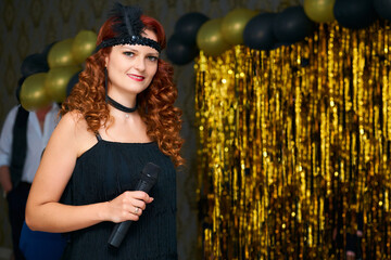 Cute event host woman, wedding presenter in black in vintage style on a gold 