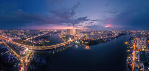 Aerial sunset view at Landmark 81 - it is a super tall skyscraper and Saigon bridge with development buildings along Saigon river light smooth down, Saigon skyline