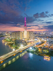 Aerial sunset view at Landmark 81 - it is a super tall skyscraper and Saigon bridge with development buildings along Saigon river light smooth down, Saigon skyline