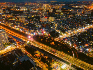 Fototapeta na wymiar Aerial view of a buildings with highway at night in Ho Chi Minh city, Vietnam