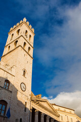 Medieval People's Tower in Assisi Communal Square, a city landmark, with clouds
