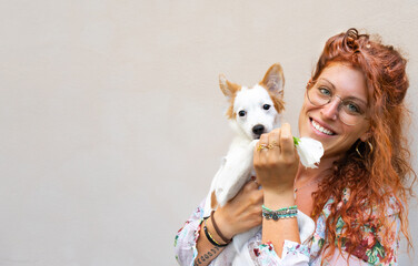 young woman with cute dog , jack russell portrait with her beautiful girl , white background , smiling happy little animal puppy .red hair  blue eyes 