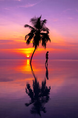 Sunset on Maldives island. Beautiful sky and ocean and beach with palms background for summer...