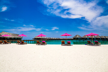 Landscape on Maldives island. Beautiful sky and ocean and beach with palms background for summer vacation holiday and travel concept. Luxury travel.