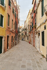 Empty narrow cobbled street in Venice, Italy. High quality photo