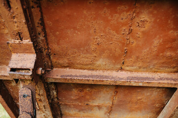 Old rusted metal plate texture with seams, bars, dents