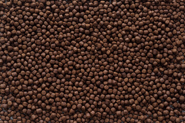 Animal feed mixed from finely ground protein powders of both plants and animals is pelleted to be used as pet food because pellets are convenient and accurate in feeding quantity.Copy Space background