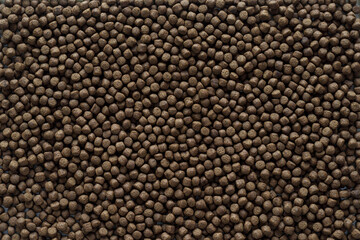 Animal feed mixed from finely ground protein powders of both plants and animals is pelleted to be...