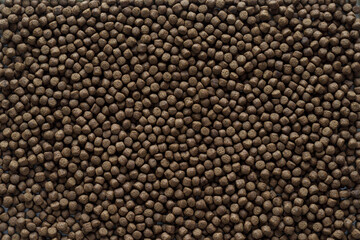 Animal feed mixed from finely ground protein powders of both plants and animals is pelleted to be used as pet food because pellets are convenient and accurate in feeding quantity.Copy Space background