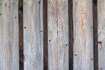 Two layered wooden wall made from white and dark boards. Rustic texture.