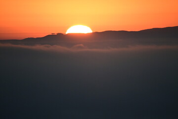 sunrise behind clouds