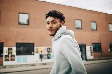 Side view portrait of smiling young man on street