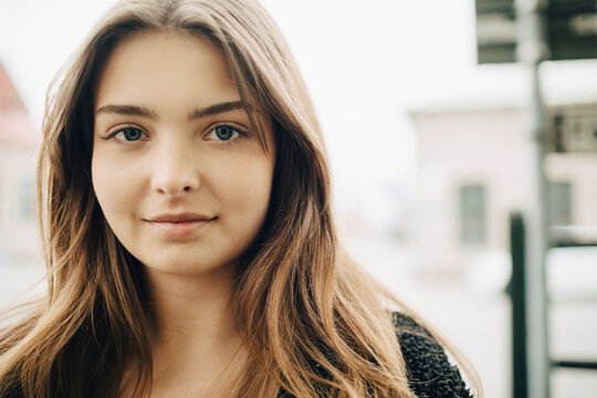 Portrait of smiling young woman with brown hair