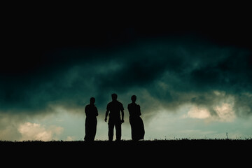 Fototapeta na wymiar silhouette of three people 