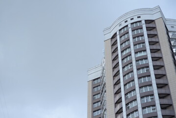 modern buildings against the background of a cloudy sky, a green new building a large number of windows, entire buildings in Ukraine, the top angle of the photo