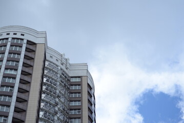 modern buildings against the background of a cloudy sky, a green new building a large number of windows, entire buildings in Ukraine, the top angle of the photo