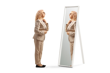 Woman getting ready and looking herself in the mirror