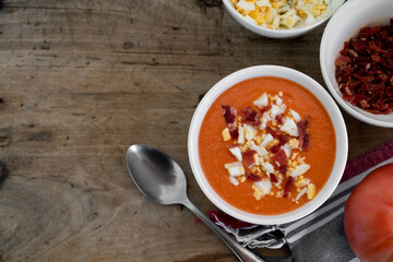Traditional spanish salmorejo soup on a rustic wooden table