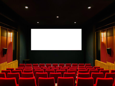 Interior of art cinema movie house red soft seating in a row. Large flat white screen mock-up on the wall for advertising.