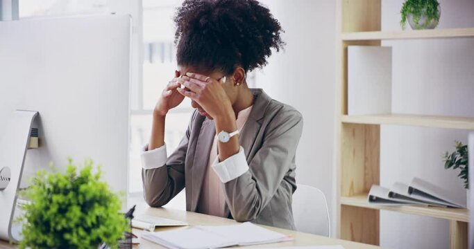 Stress business woman suffering from a headache or migraine or mental health while working on computer in a work office. Upset and anxiety with burnout and tired while working overtime for a deadline