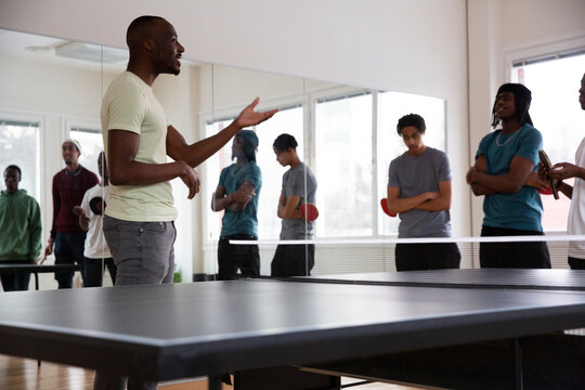 Instructor interacting with students during training session in games room