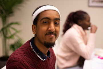 Portrait of smiling student sitting in classroom