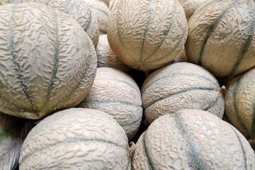 Fototapeta na wymiar Stack of cantaloupes on a market stall