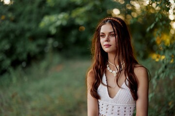 Naklejka premium A woman dressed as a hippie with pigtails on her head travels outdoors at a campground in the fall and enjoys life