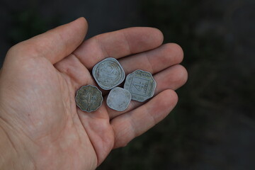 Vintage coins of old India in hand