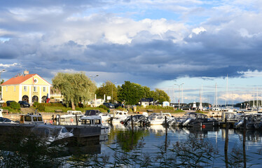 Fototapeta na wymiar Marina in the archipelago with sunshine and rain