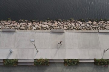 Woman running on concrete captured from above