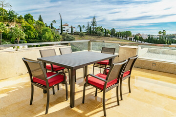 Fototapeta na wymiar a dining table on a luxury terrace overlooking the Mediterranean coastline 