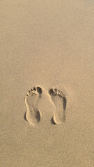 Two Footprints in the sand on the beach