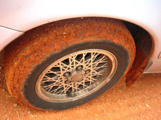 Tyre covered in red outback sand