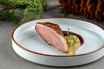 Duck Breast with pear, decorated with herbs. Haute cuisine, beautiful presentation.