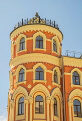 Obraz premium The round tower of the old house is stylized in the Gothic style