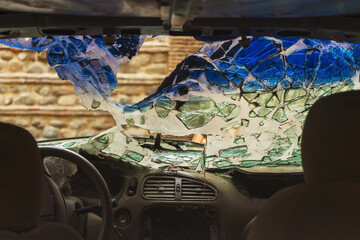 broken car windshield from an accident. a car hit a man at high speed. huge damage to the car from a collision on the road. wrecked car due to vandalism © Yashkin Ilya